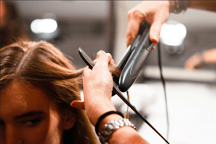 woman getting hair straightened