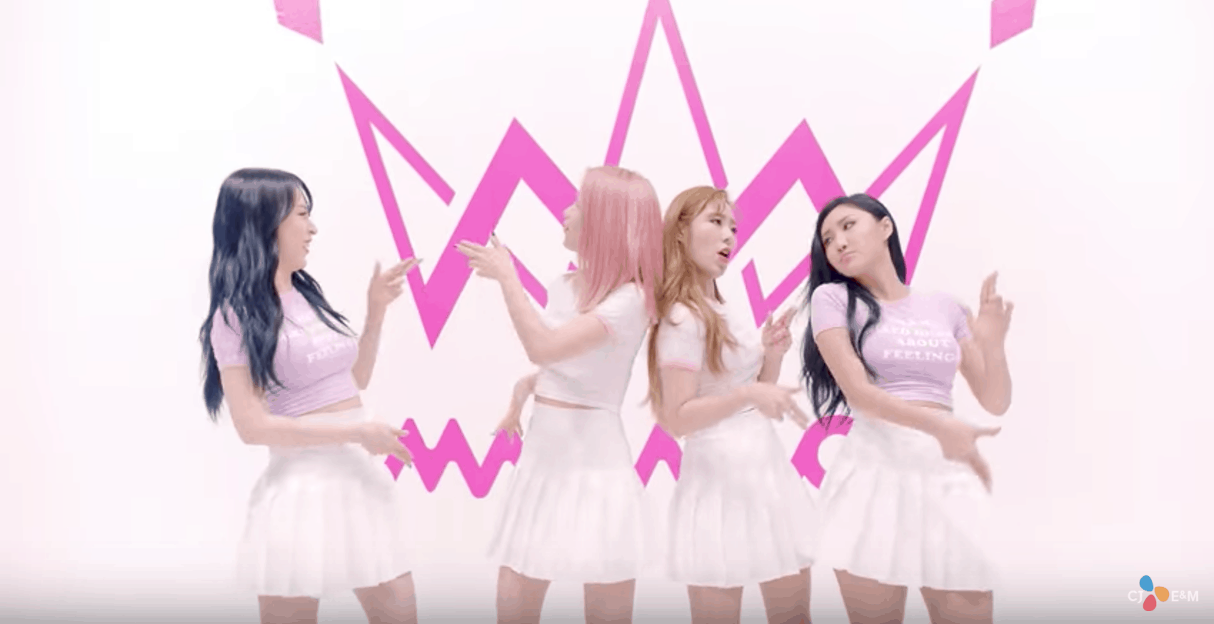 Mamamoo Yes I Am fashion: The girls wear pink and purple tops with white skirts in front of a pink background in the music video