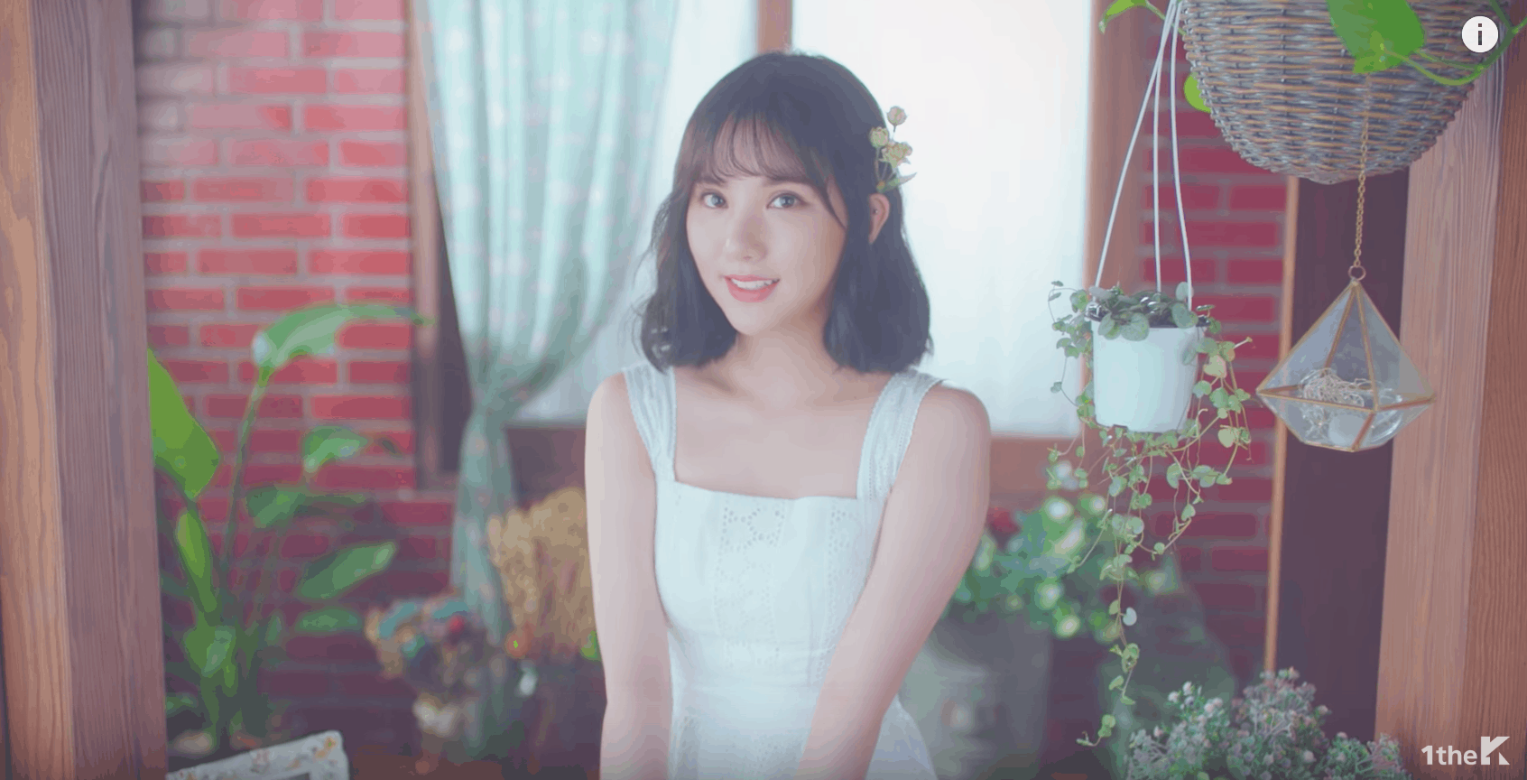 GFRIEND Love Whisper music video: Girl wears a white dress and a flower in her hair