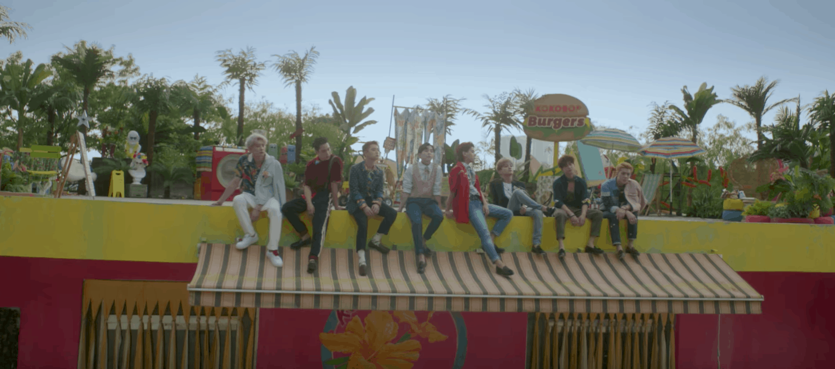 EXO Ko Ko Bop video - The boys sitting on the roof of a burger joint