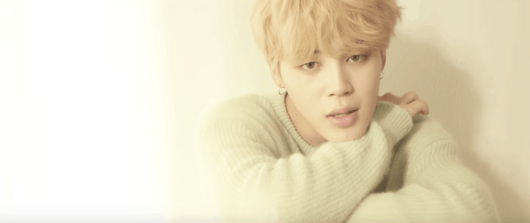 BTS Serendipity music video: Jimin wearing a fuzzy gray sweater