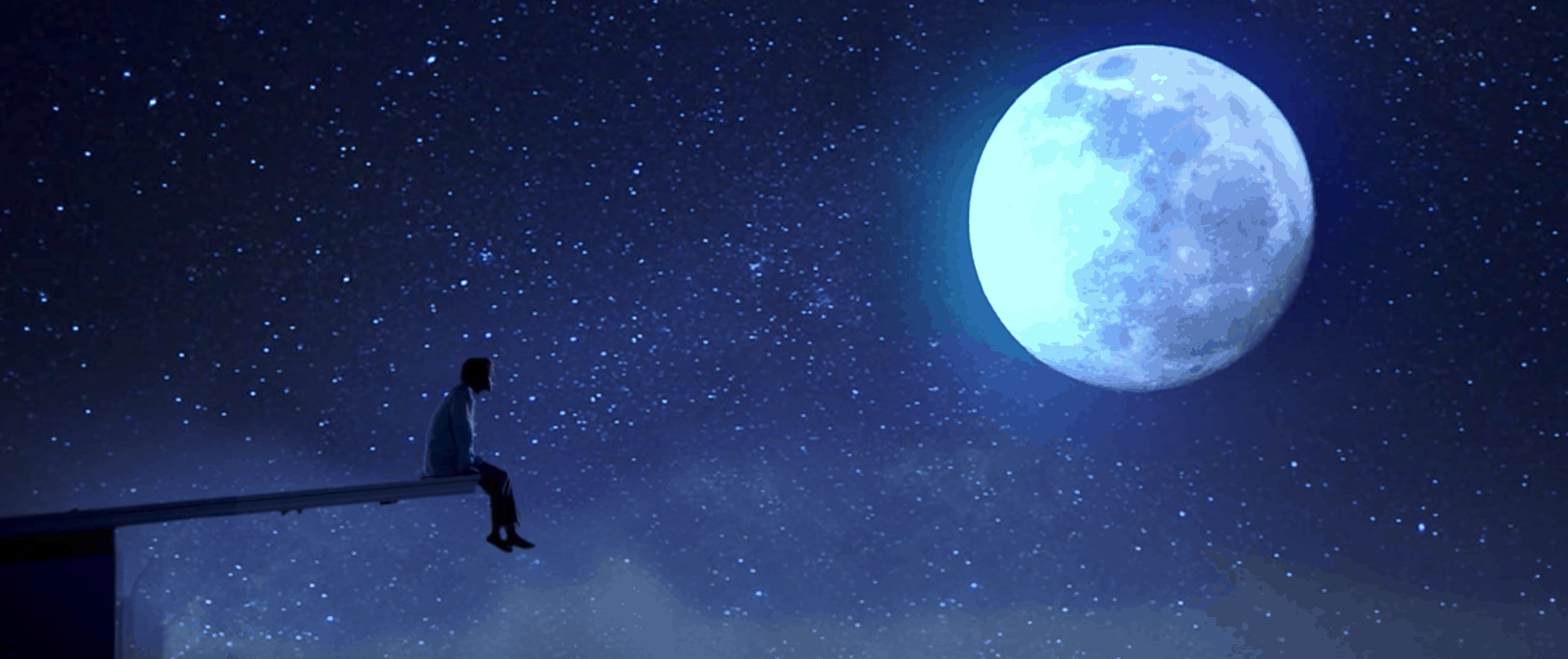 BTS Serendipity music video: Picture of a man sitting on the edge of a rock jutting out into the sky, under a bright full moon