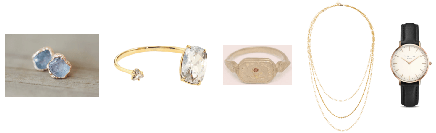 Raw sapphire earrings set in rose gold, gold cuff bracelet with large clear stone at one end and small clear stone at the other, brass wax seal ring with "Forget Me Not" engraved backwards and orange sapphire set in engraving of forget-me-not flower, gold triple-strand chain necklace, watch with 33mm case, rose gold hardware, and black leather band