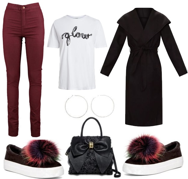 Slogan tee outfit: How to wear a graphic tee shirt with dark red jeans, a long black coat, pom pom sneakers, a top-handle bag and hoop earrings