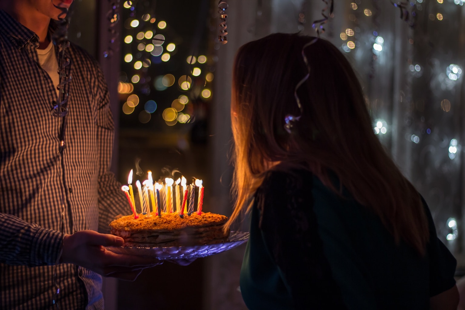 Person blows out candle