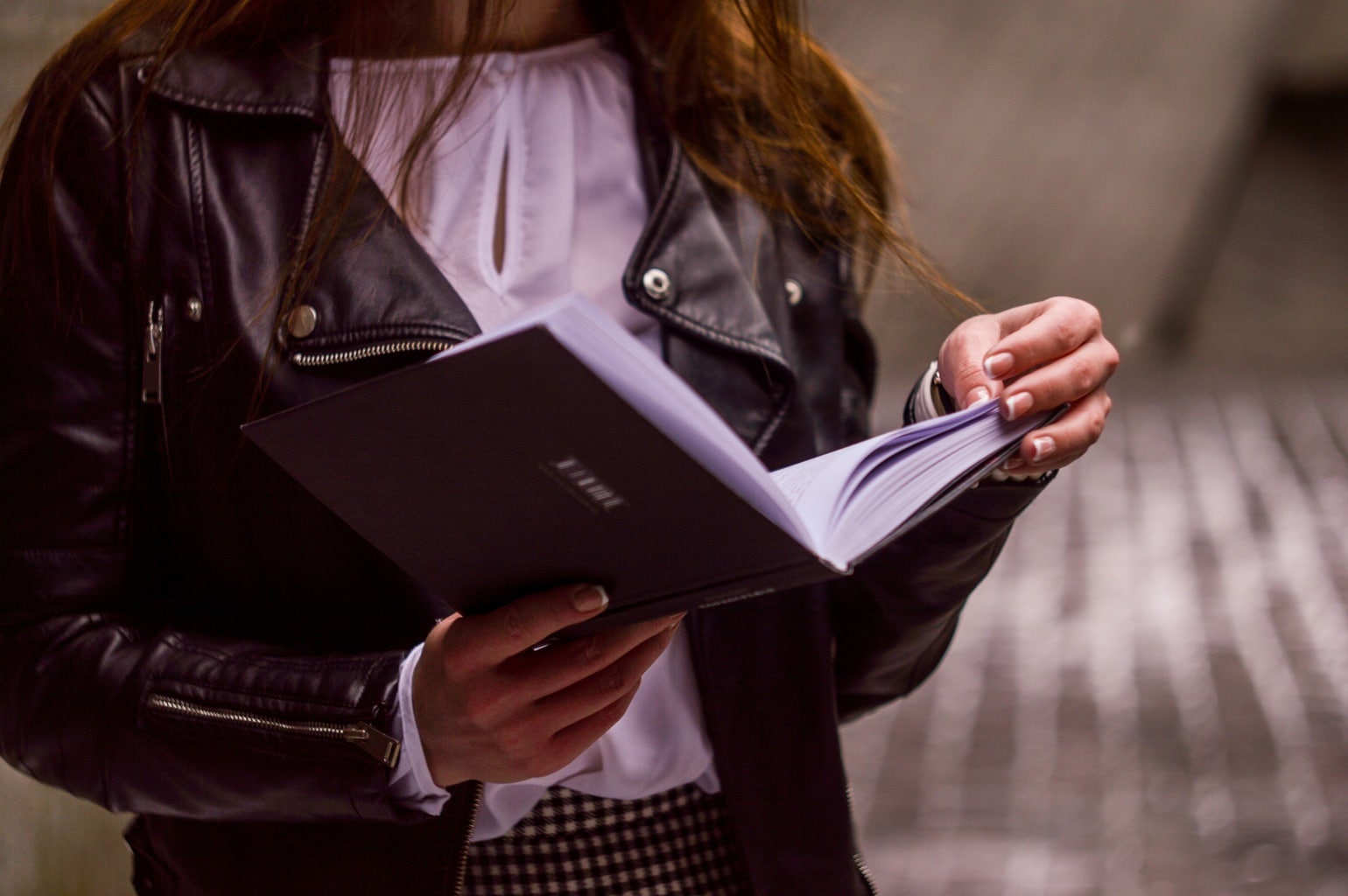 College age girl reading a book