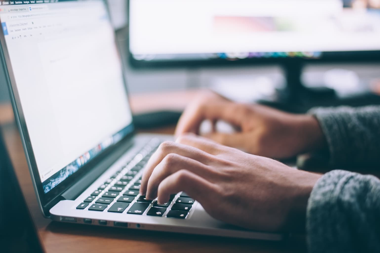 Person typing on a laptop computer