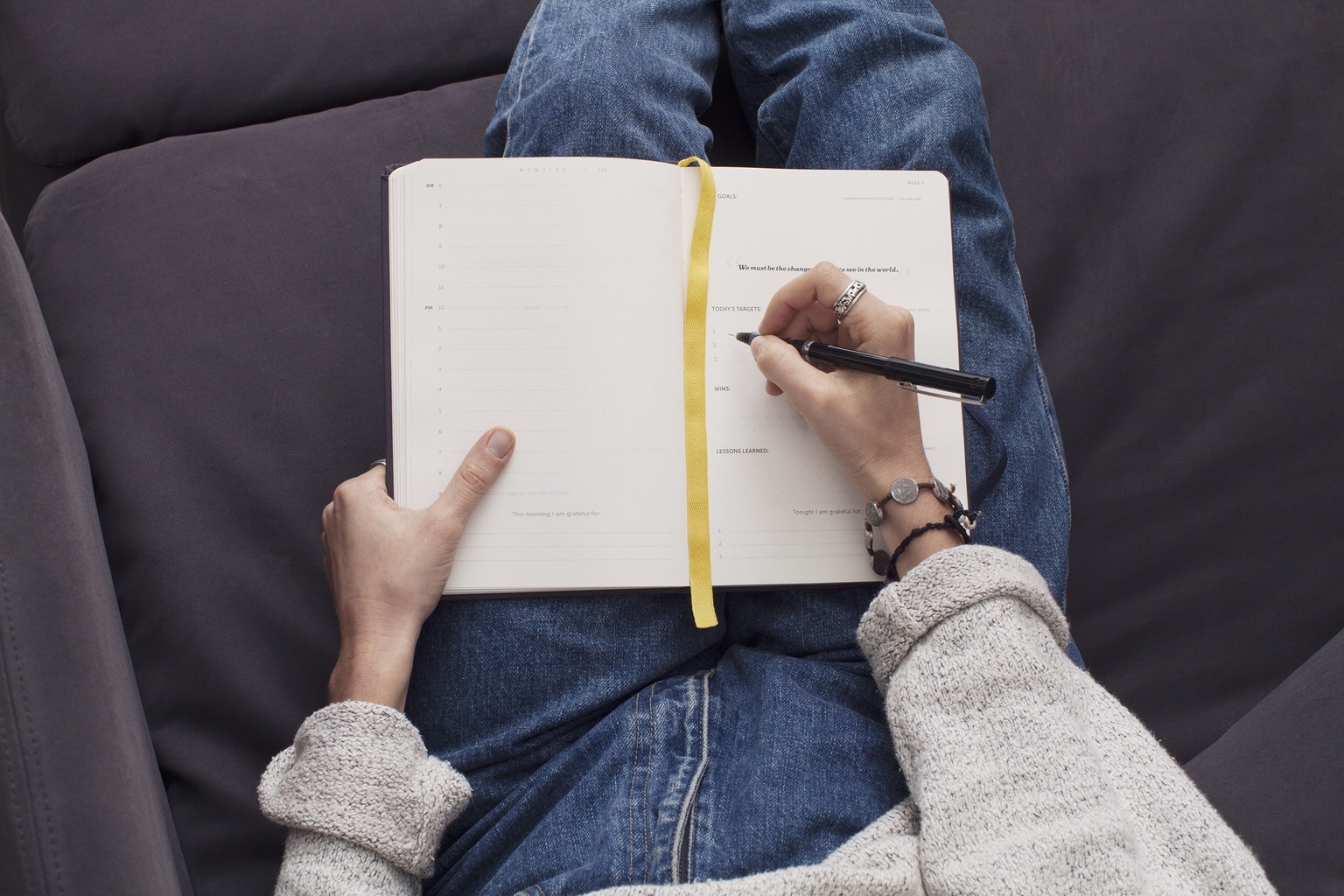 Girl with blue jeans writing in journal