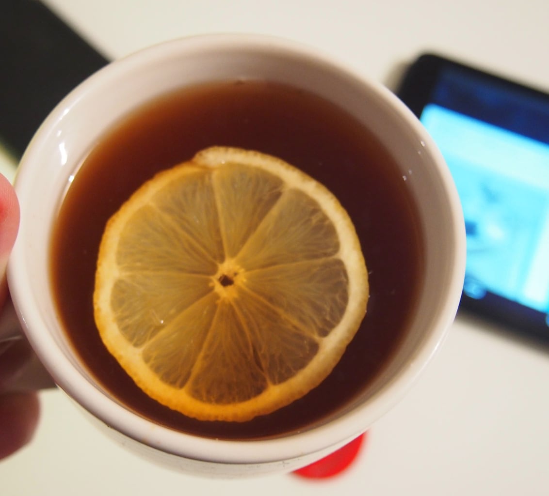 Cup of cider or tea with an orange slice on top