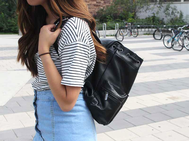 Striped shirt, denim skirt, black bag
