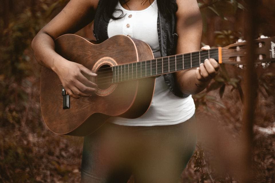 Young woman playing the guitar