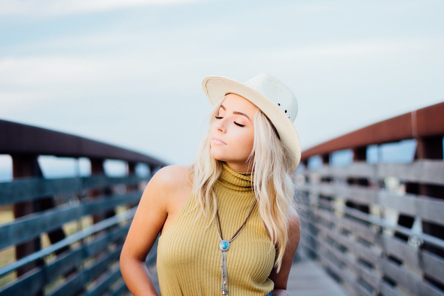 Girl in the summer wearing a hat and necklace