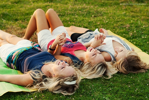 Summertime friends laying on blanket