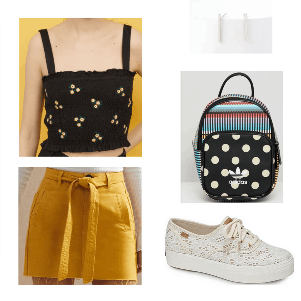 black floral crop top, mustard skirt, silver earrings, black patterned backpack, lace white sneakers