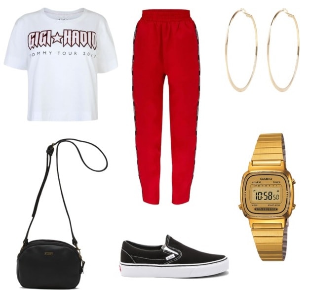 track pants going to class style with hoop earrings, gold watch, white graphic tee, black vans, and black shoulder purse.