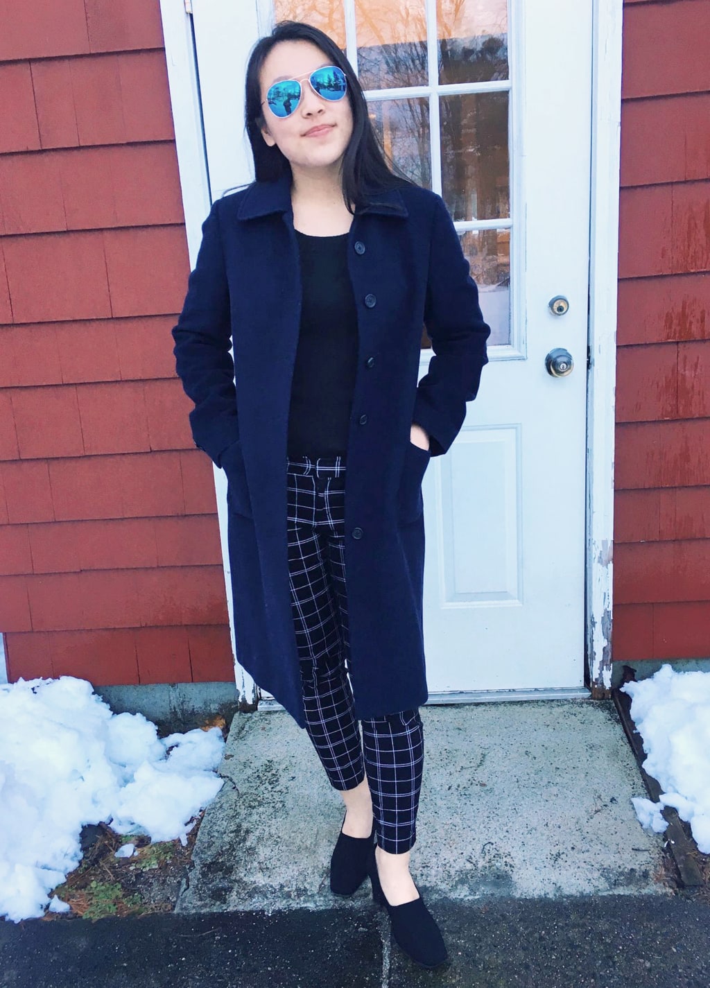 UMass Amherst fashion: Yan Ni sports a black sweater and mid-rise plaid skinny professional pants. She tops off her look with a long navy peacoat and black chunky-heeled shoes.