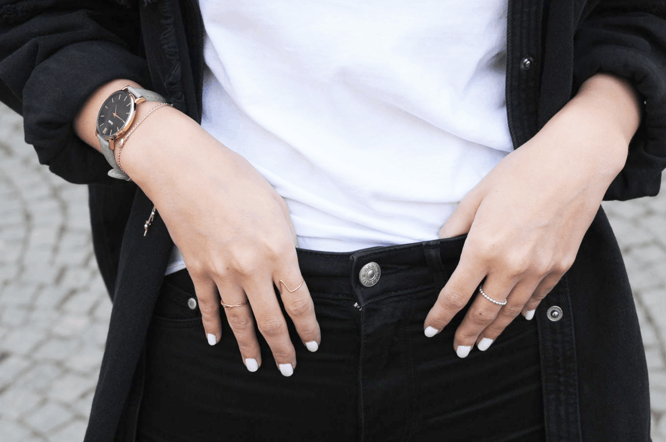 Unique rings and a sophisticated watch on campus at the University of Vienna in Austria. Student Anika wears white nail polish and rocks skinny black jeans and a white tee shirt.