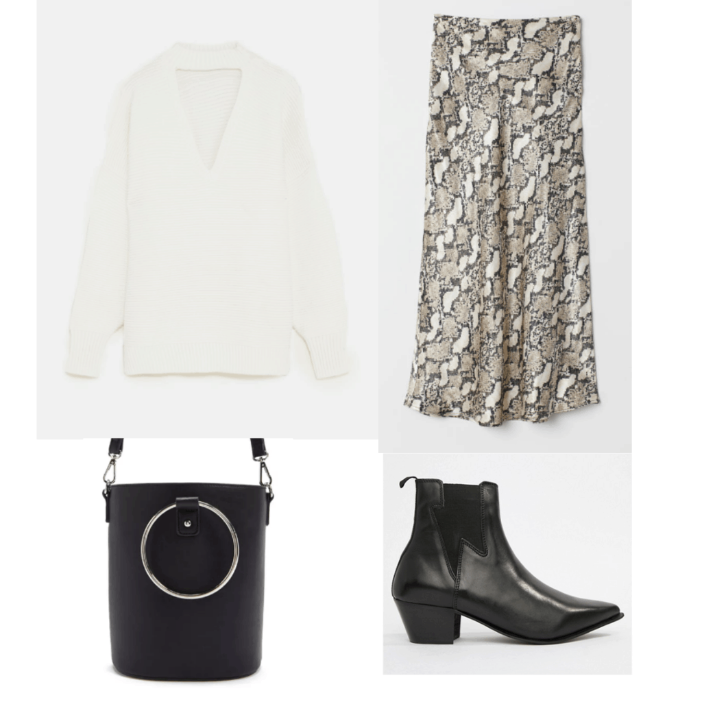 Snakeskin print skirt outfit with cream colored sweater, black bucket bag, and black pointed toe ankle boots