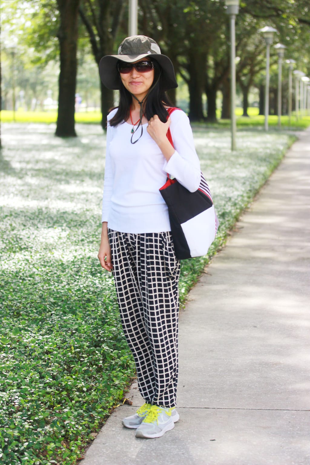 USF Fashion - student wears checkered pants, camo hat, white long-sleeve shirt, and athletic sneakers on campus