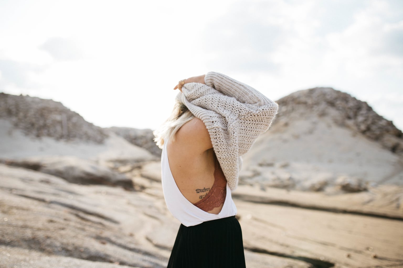 Girl putting on a sweater