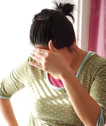 Woman Covering Face with Hand