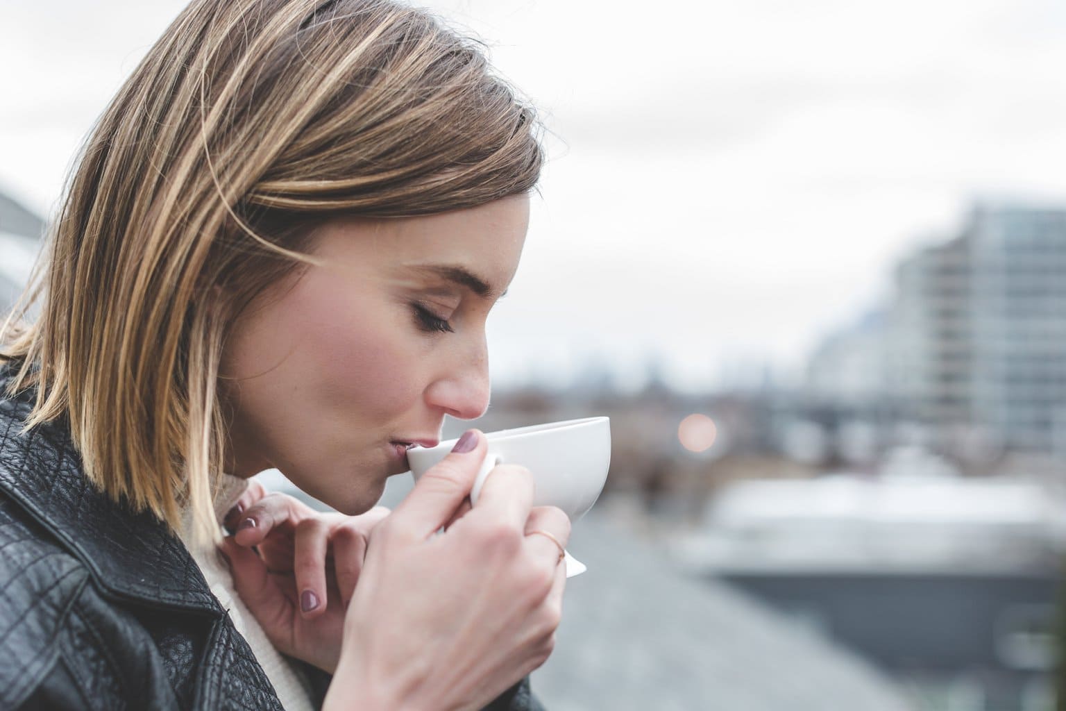 Woman drinking coffee on a rooftop