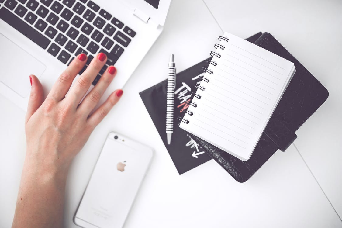 woman at laptop with books