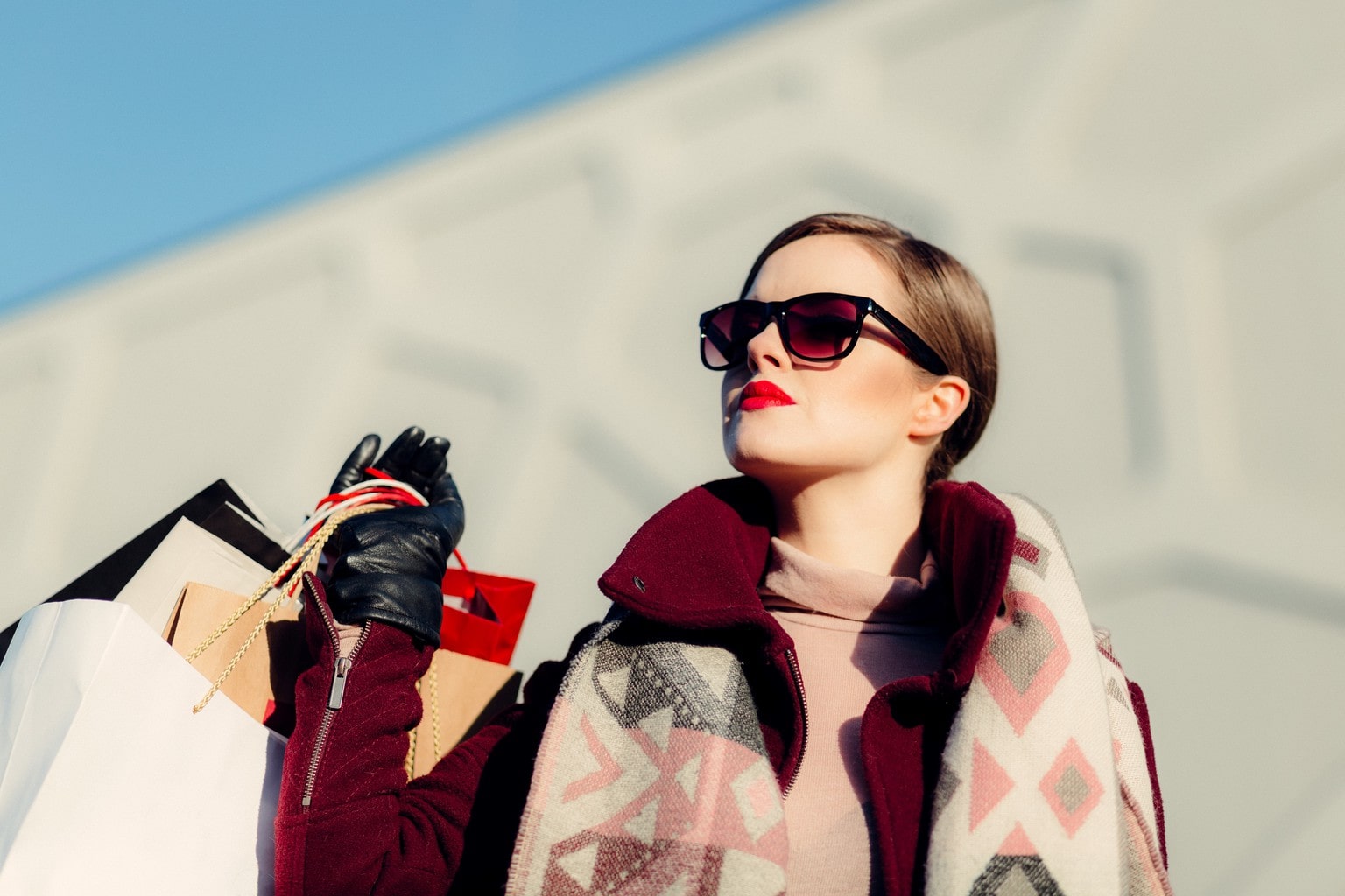 Woman in Sunglasses Holding Shopping Bags