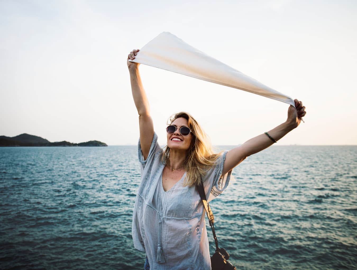 Woman smiling in a good mood by the beach