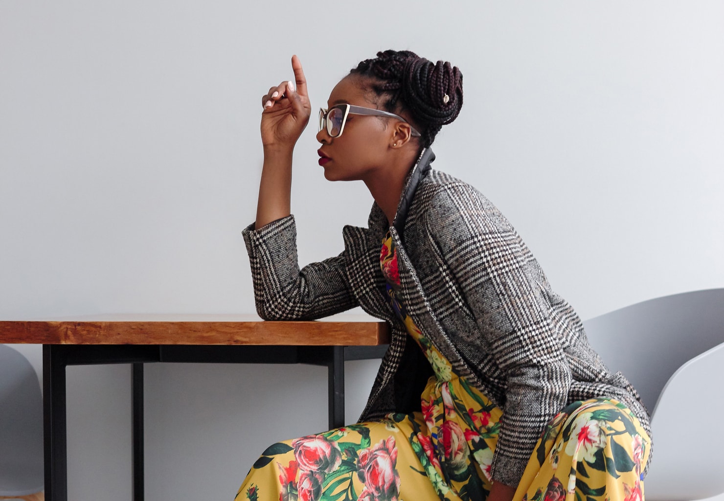 Woman wearing mixed prints - floral dress and plaid blazer