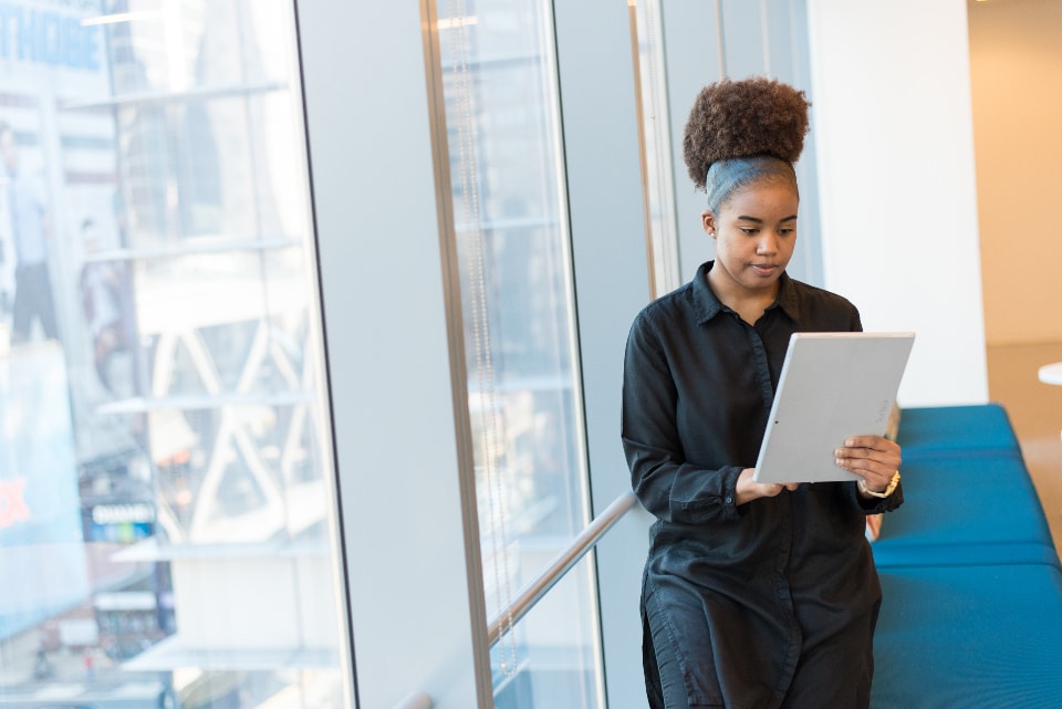 Woman working in an office with a tablet