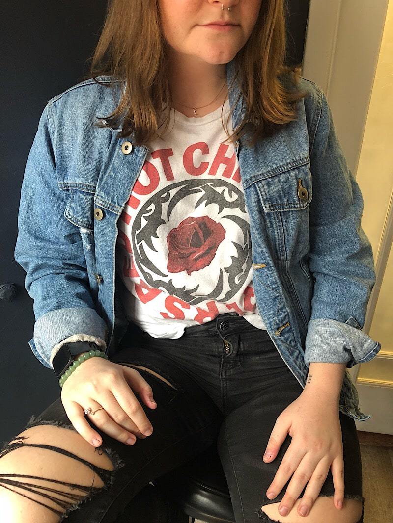 WVU student Tiana wears a Red Hot Chili Peppers graphic tee with a mens denim jacket.