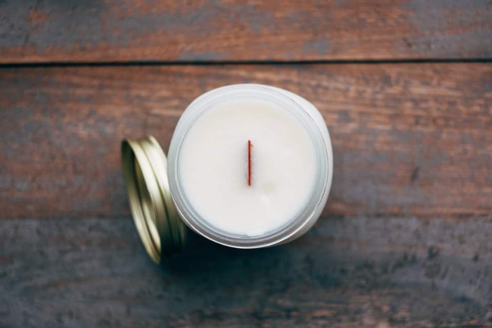 white candle with gold lid