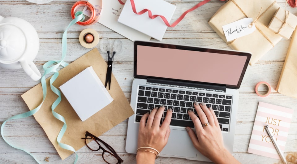 Laptop surrounded by office supplies