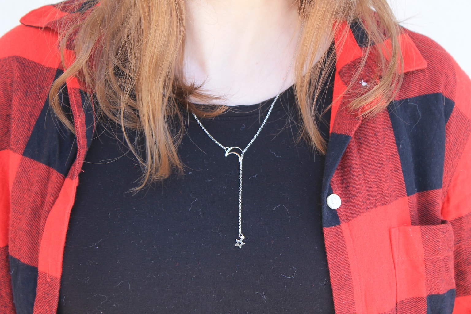 Genna's necklace is a simple lariat with a moon and star.