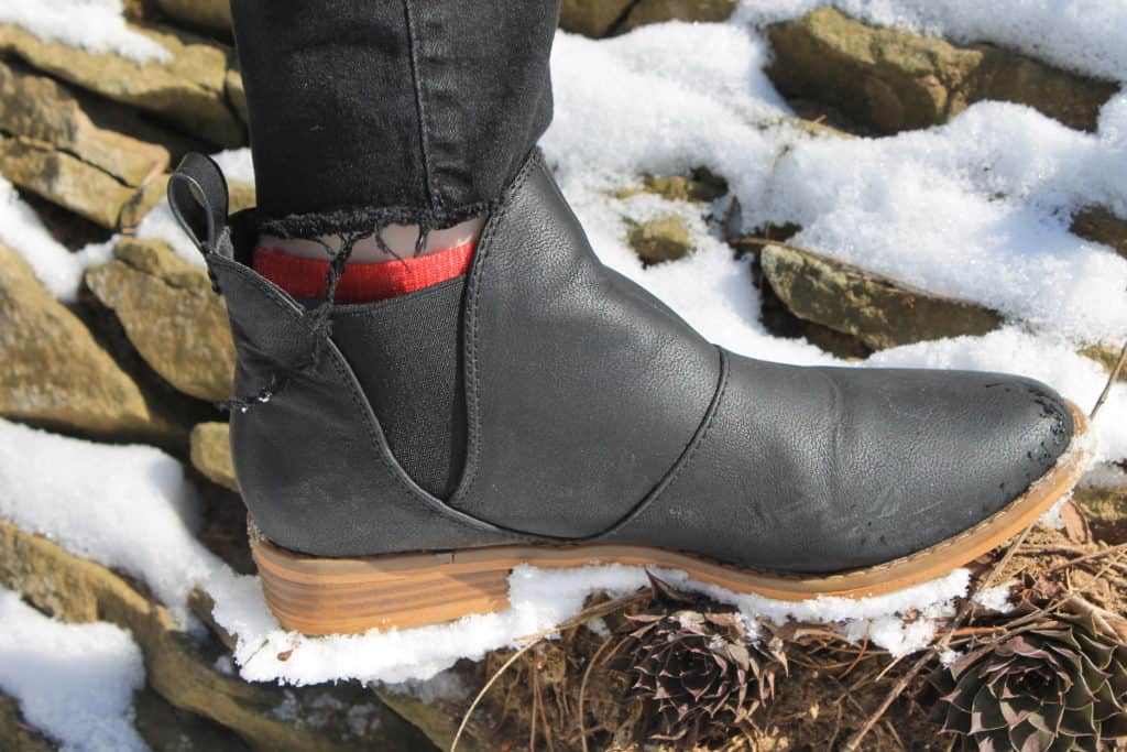 Genna wears weatherproof black Rocketdog chelsea style booties.