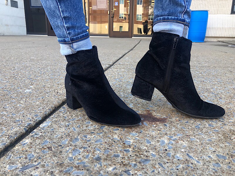 Bella sports chunky low-heeled black booties.