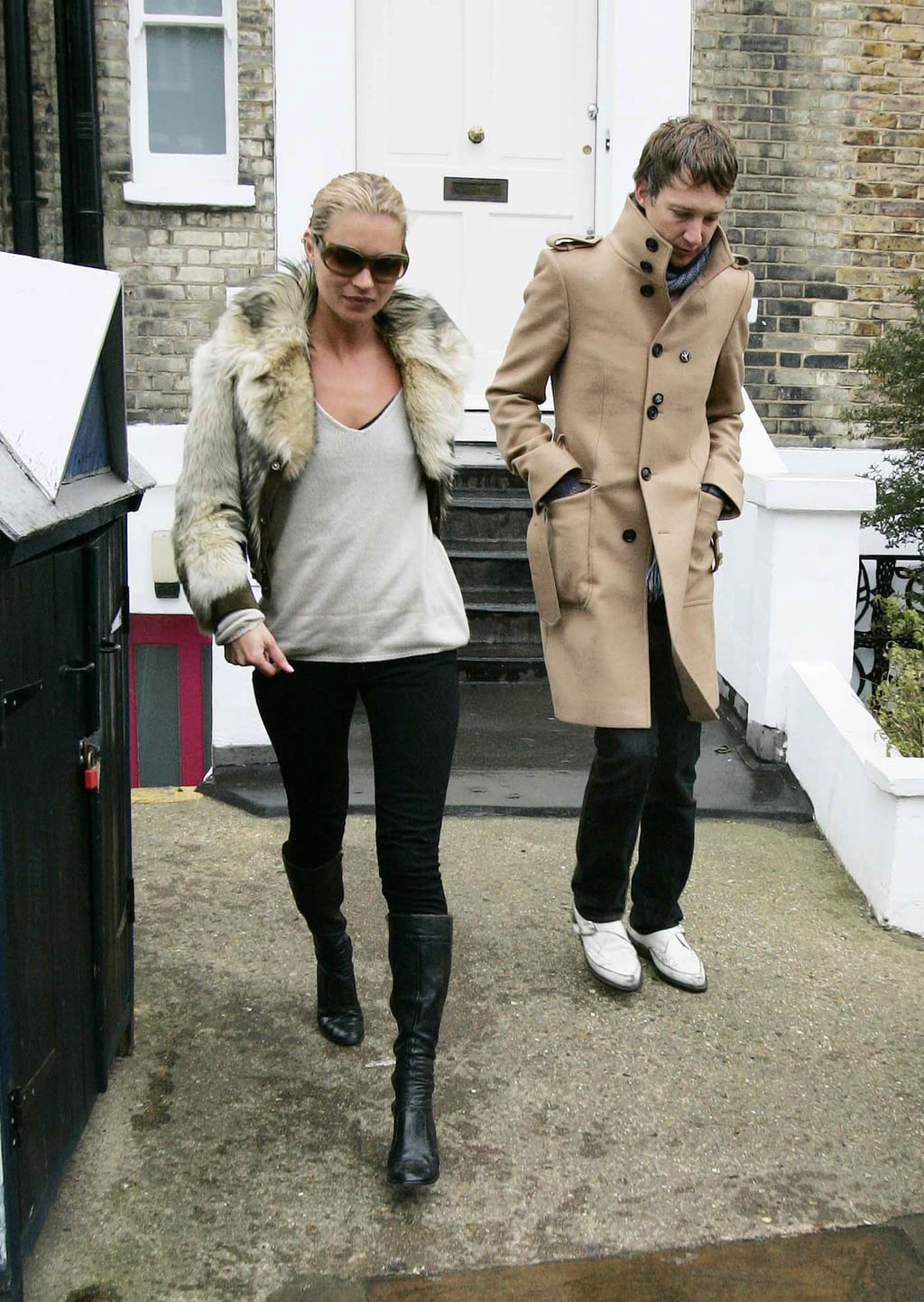 kate moss wearing boots, skinny jeans, a sweater, and fur jacket