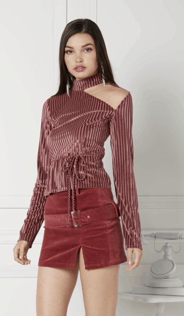 model wearing a velvet corduroy blouse and mini skirt