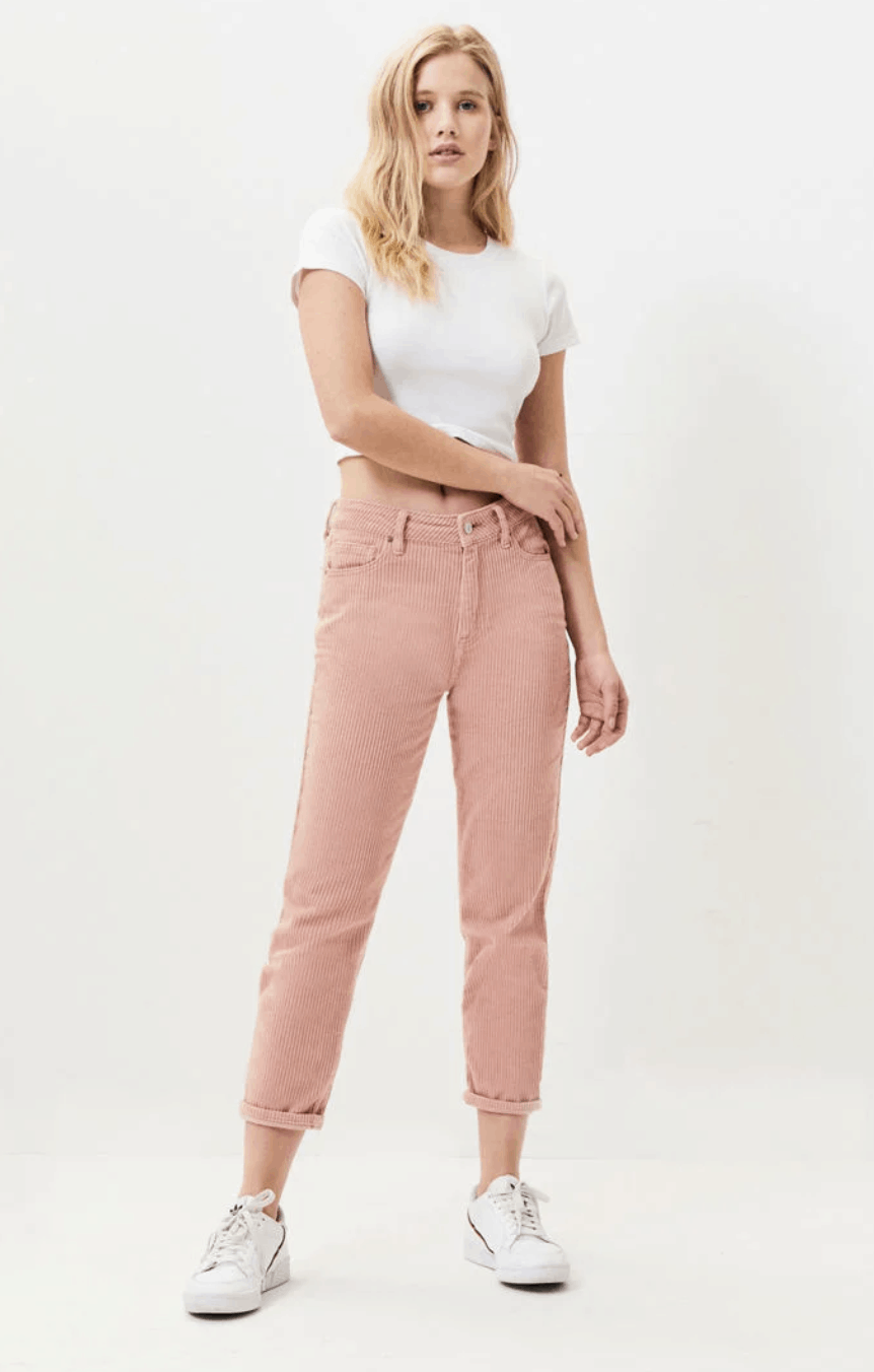 model in white cropped tee and pink corduroy pants