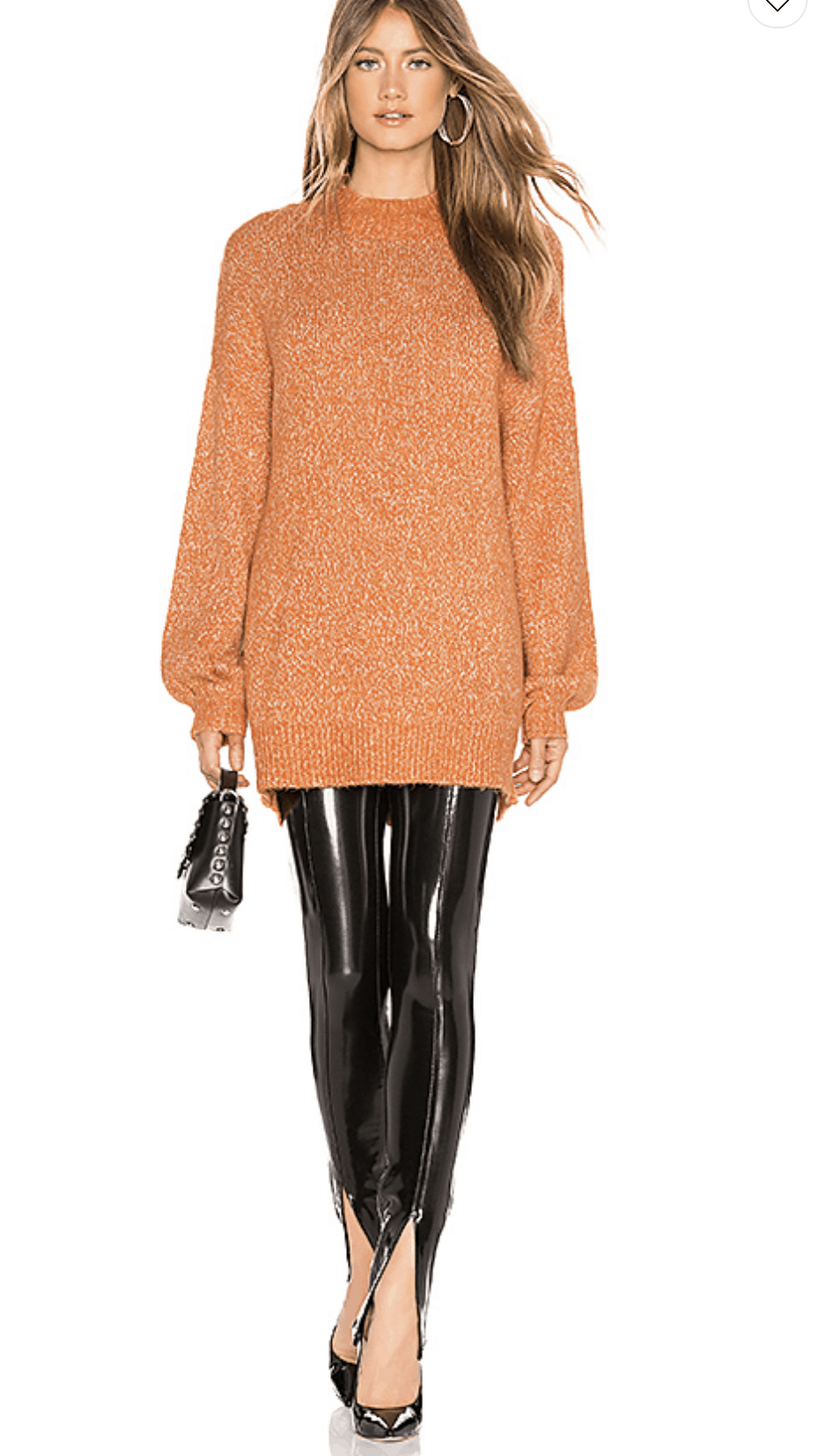 model wearing a orange sweater, leather leggings, black pumps and black handbag