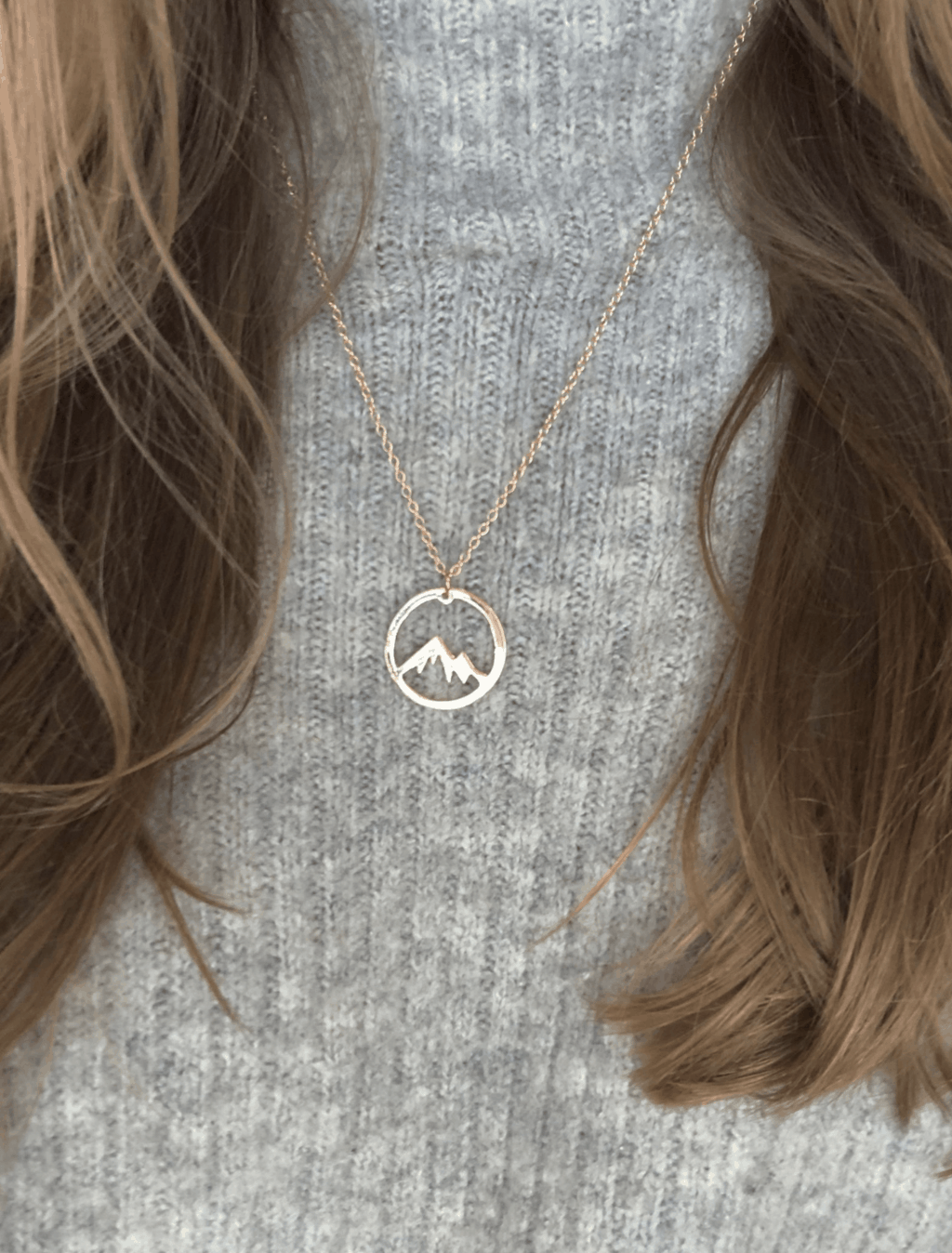 circle silver necklace with mountain shape inside