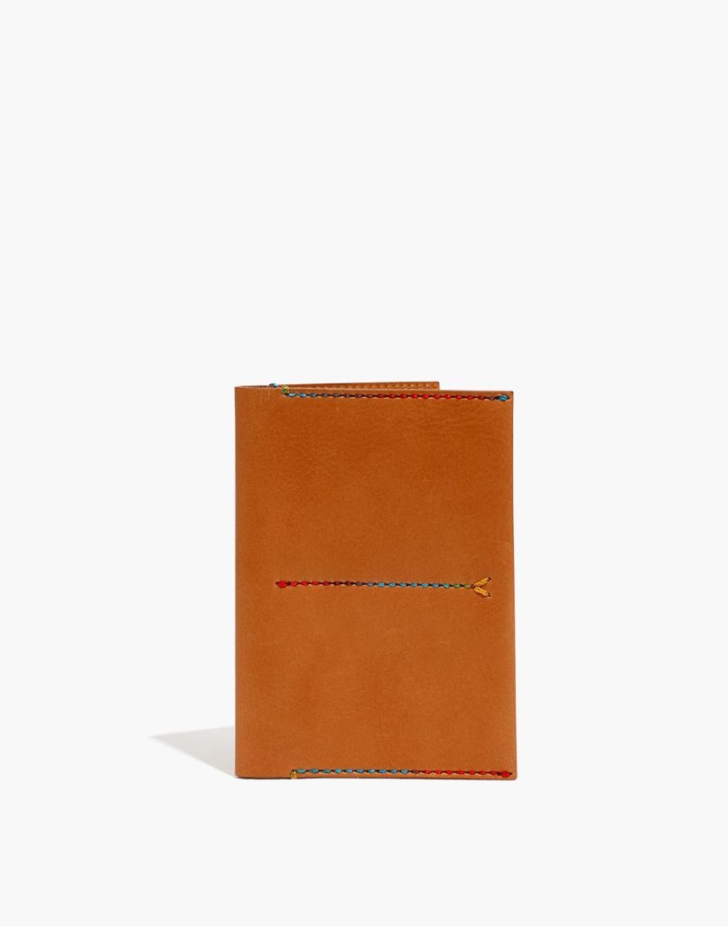 Cognac brown leather passport holder with rainbow-colored stitching