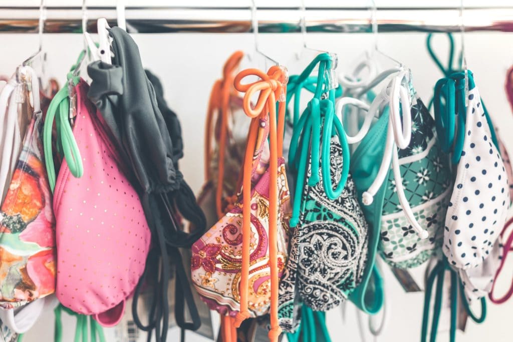 Multicolored bikinis hanging on rack