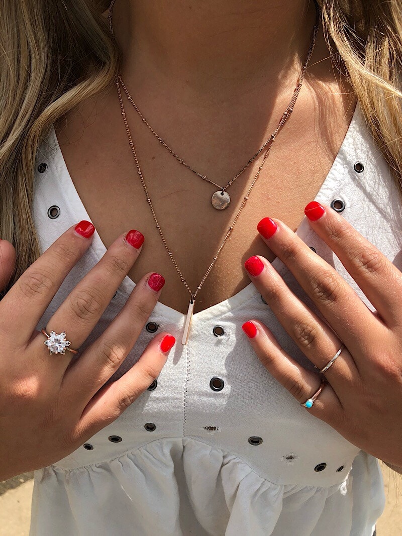 Kelsey wears mixed metals; layered gold necklaces as well as gold and silver rings.