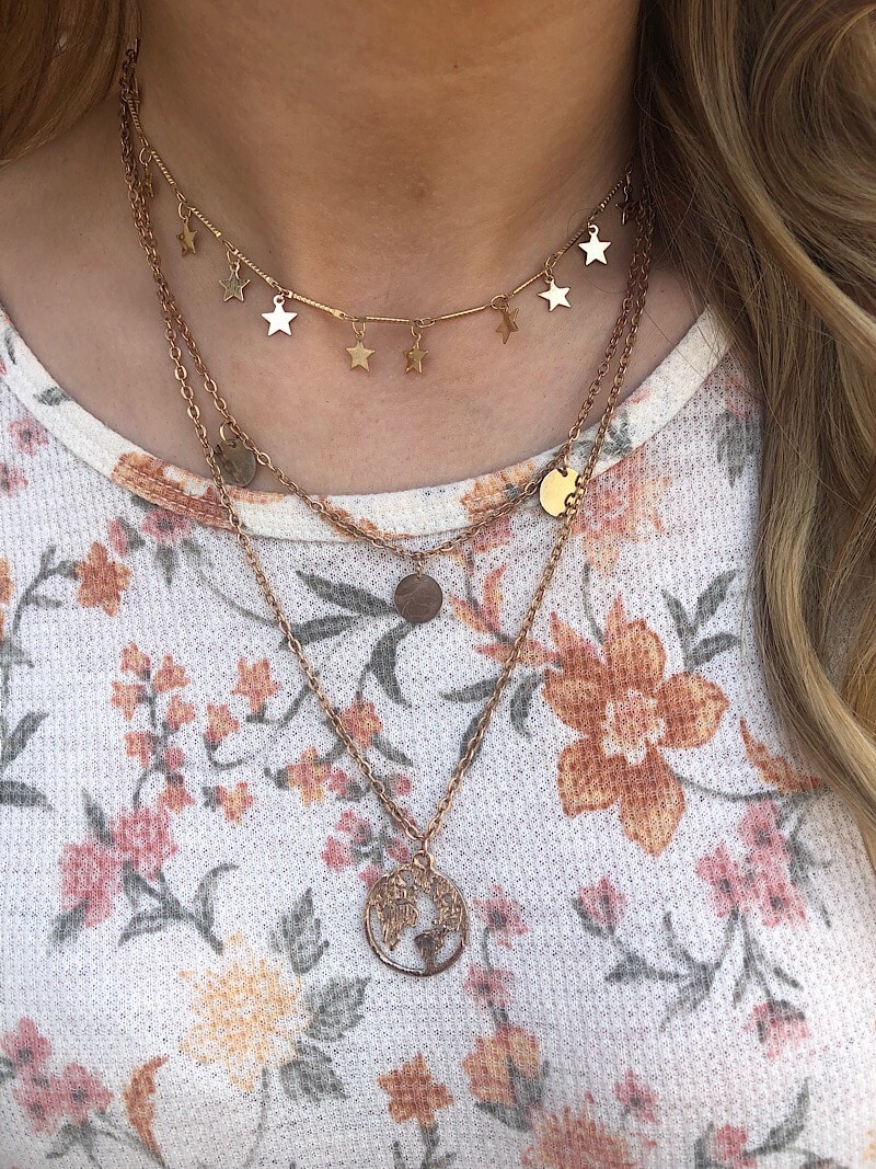 This WVU student wears layered gold pendant necklaces.