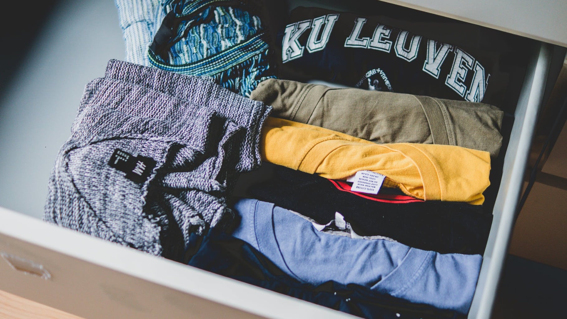 Drawer filled with folded t-shirts