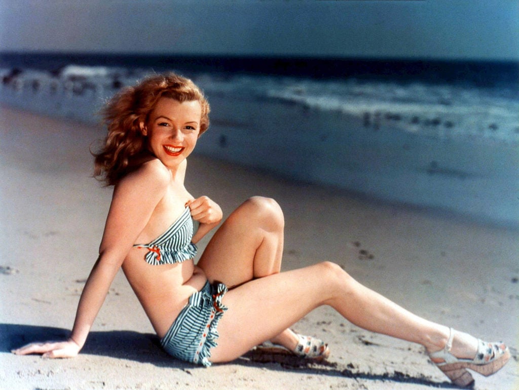 Marilyn Monroe on beach in matching striped bikini