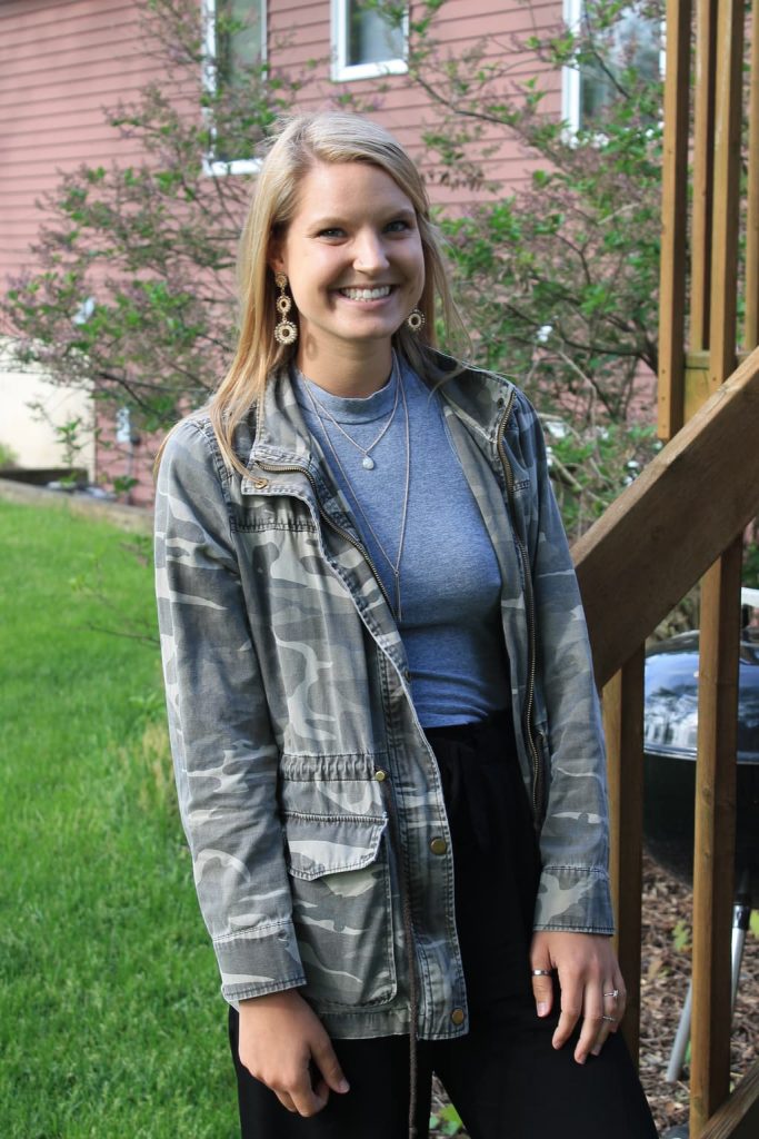 This GVSU student wears a camouflage jacket with a grey tank top and layered gold jewelry.