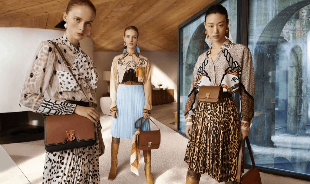 models in mixed print outfits and brown leather bags.